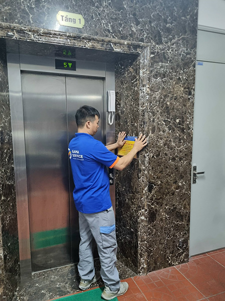 Bảo trì thang máy | Kỹ thuật viên dán thông báo bảo trì thang máy